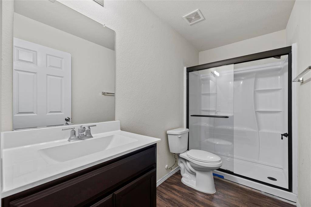 Full guest bathroom with a walk-in shower.