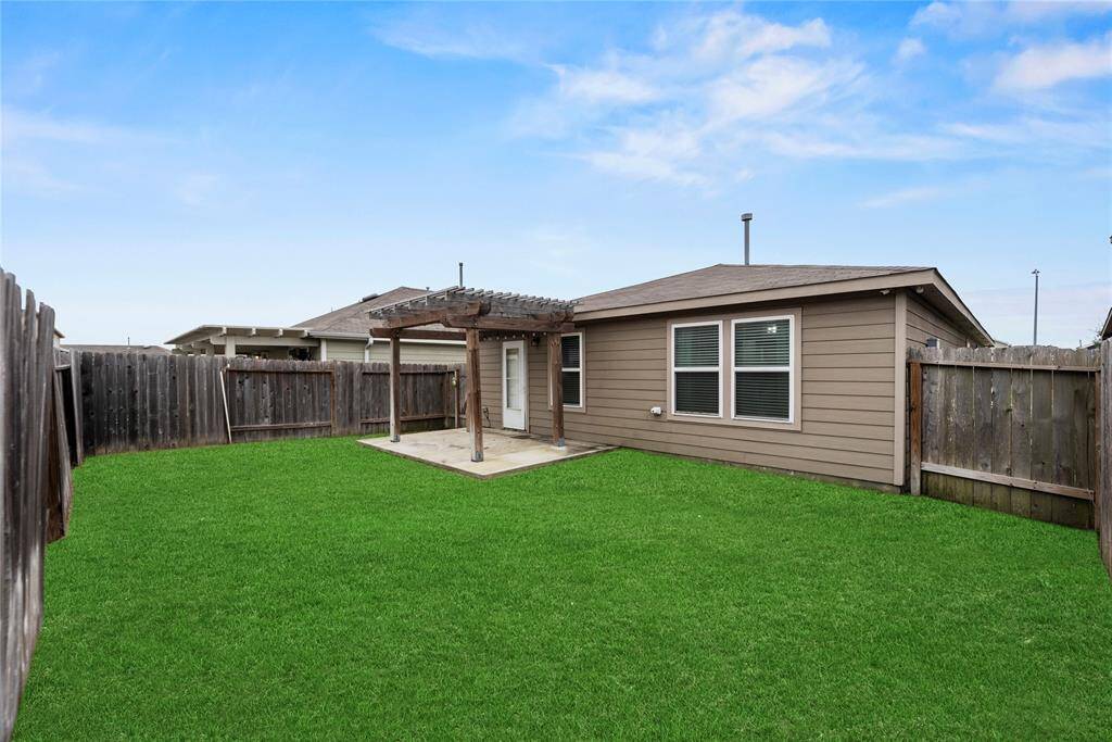 Private backyard with a patio area and Pergola. Grass has been digitally enhanced to show potential.
