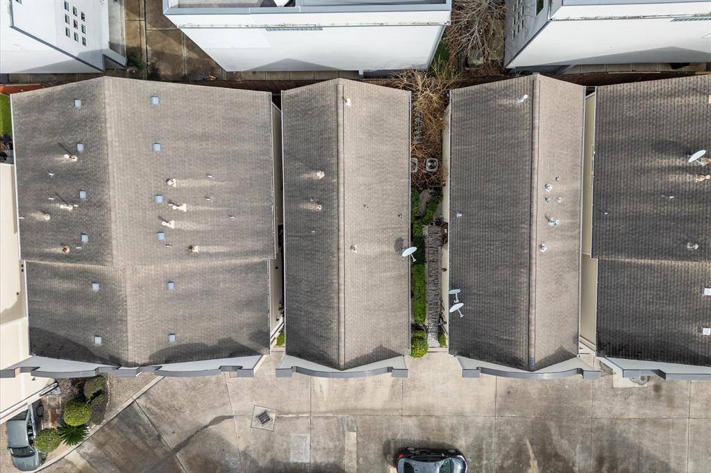 This aerial photo shows the rooftops of several adjacent townhouses. The layout suggests a compact but organized residential area, ideal for those seeking a community feel.
