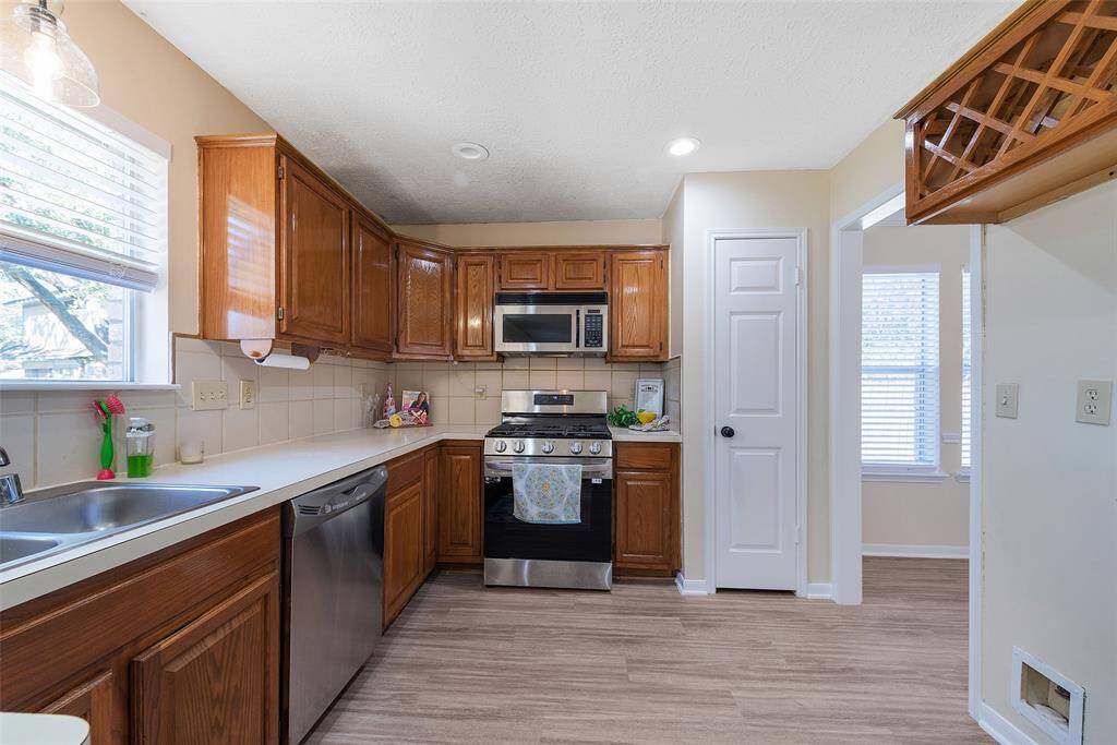 Plenty of cabinet space, pantry & built-in bottle rack above the area for the refrigerator.