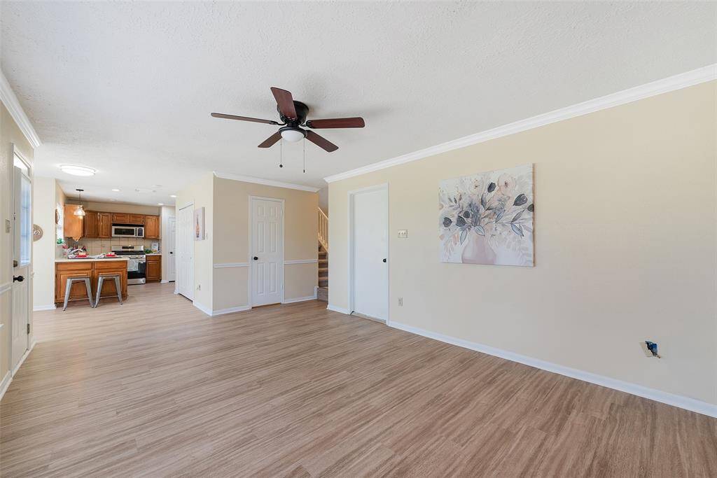 Opens to the kitchen & convenient to the guest/half bath. A door opens to the patio & spacious backyard.