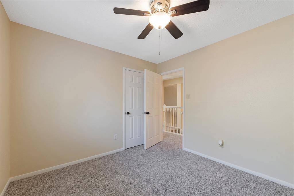 Nicely sized secondary bedroom with lighted ceiling fan.