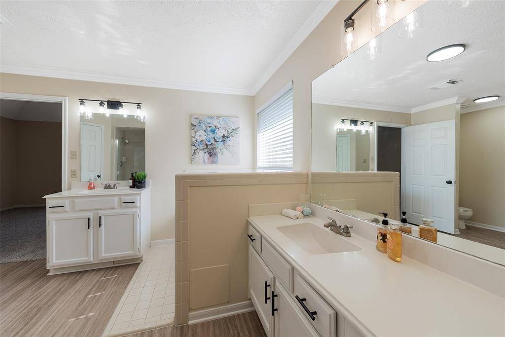 Large primary bathroom with separate vanities.