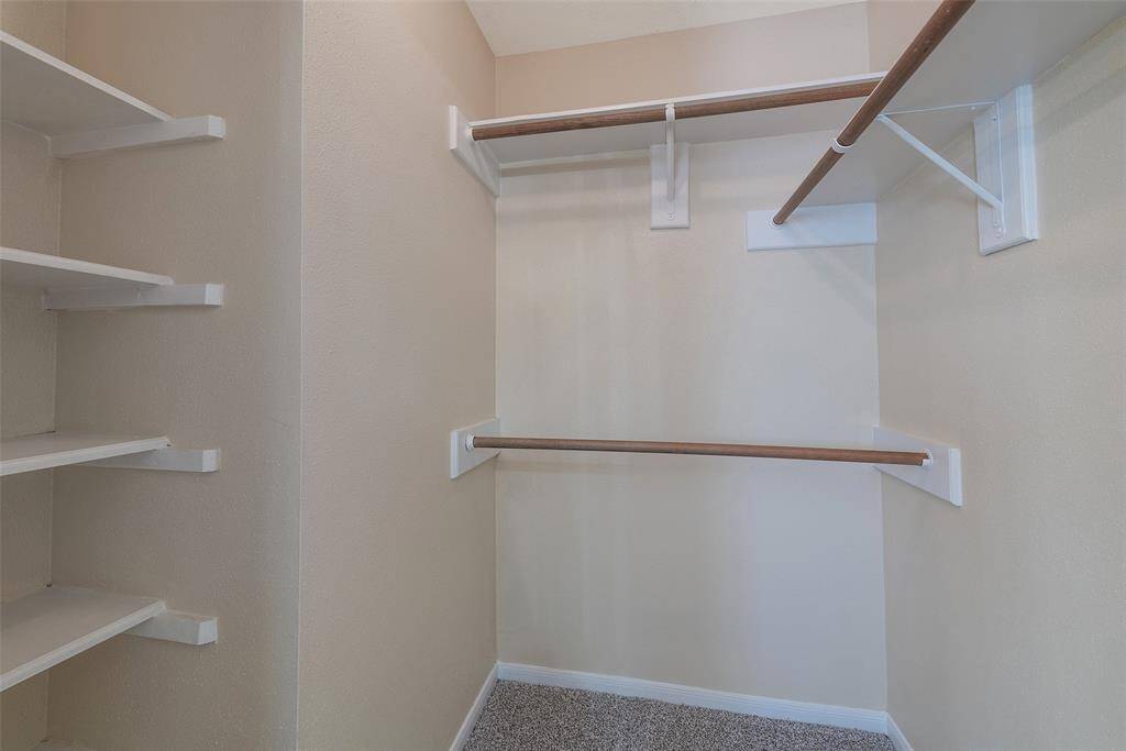 Walk-in closet with built-in shelving.