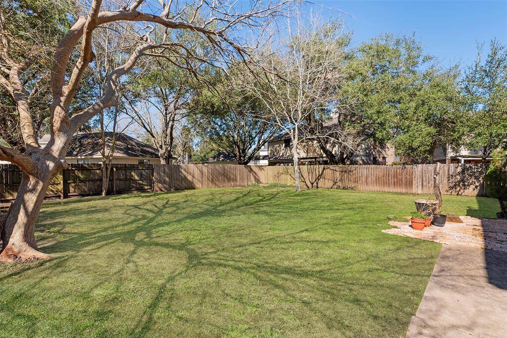 Nicely sized backyard with shade trees.