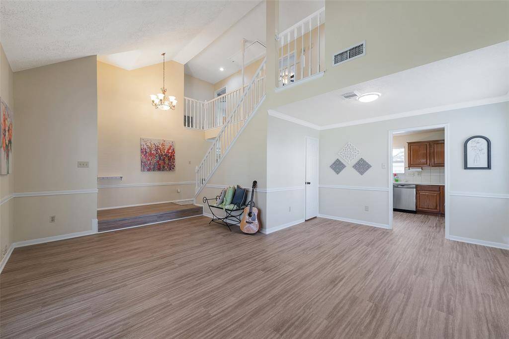 A dramatic 2 story ceiling for this area adds to the spacious & open feel. A chandelier accents the front entry & the staircase.