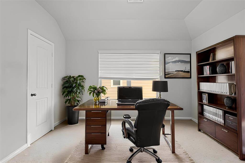 Virtually Staged: Beautiful home office where you can get some work done. It features carpet floors, and a large window with privacy blinds.