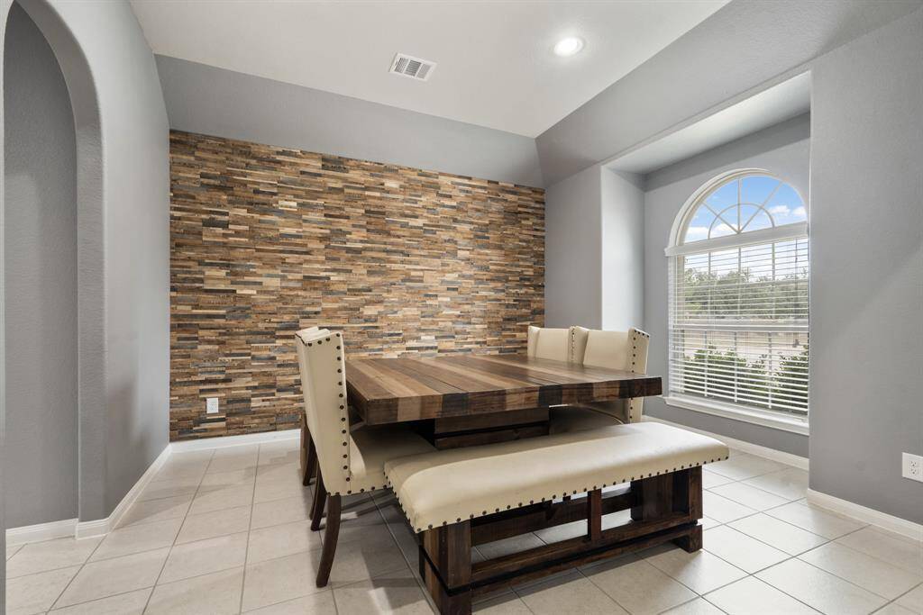 This home will instantly greet you with a spacious formal dining room that has a wood veneer accent wall.
