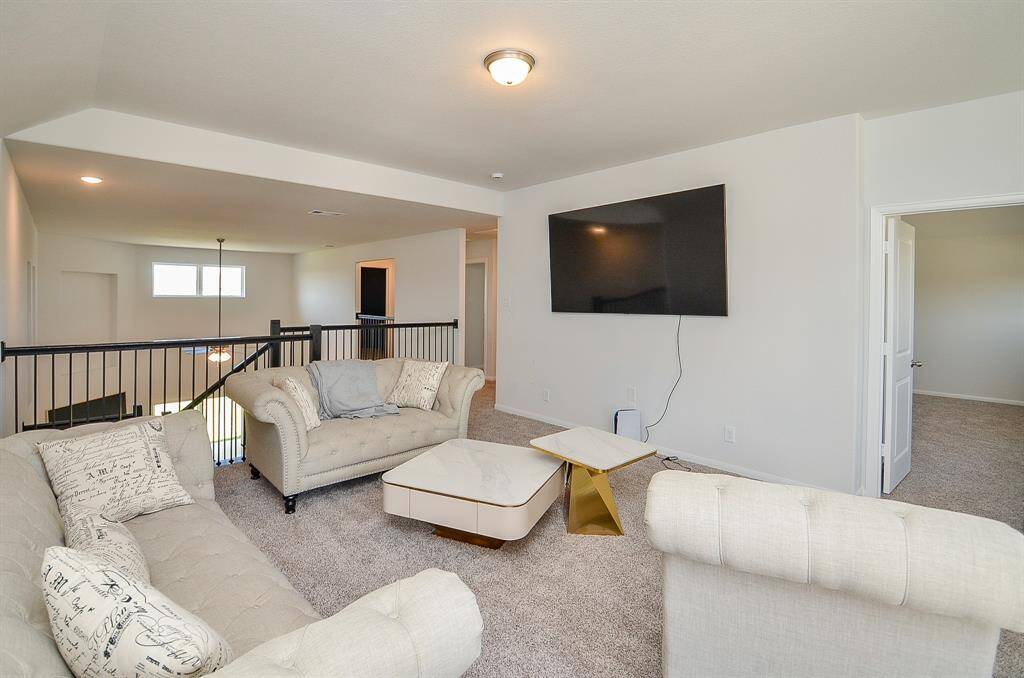 A spacious family room with ample seating and natural light.