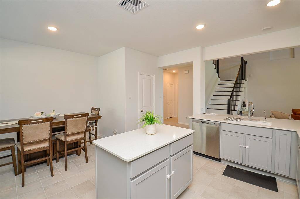 A view of the dining area adjacent to the kitchen with a contemporary table setup.
