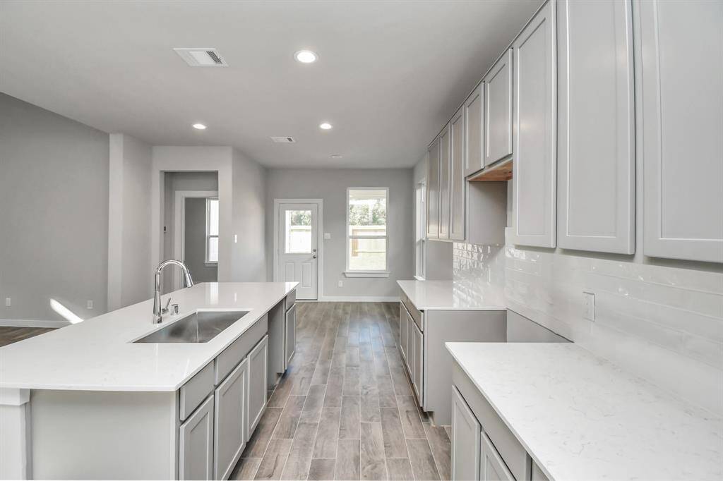 Discover another perspective of this exquisite kitchen, lavishly furnished with an ample expanse of counter space, offering tons of room for culinary creativity. Sample photo of completed home with similar floor plan. Actual colors and selections may vary.