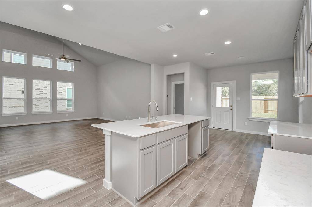 Discover another view of the kitchen that opens up to the expansive family room, creating a perfect hub for gatherings. Sample photo of completed home with similar floor plan. Actual colors and selections may vary.