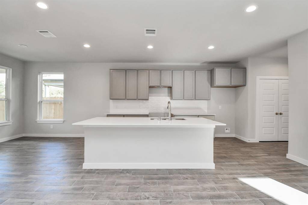 Another perspective of the spacious kitchen! Sample photo of completed home with similar floor plan. Actual colors and selections may vary.