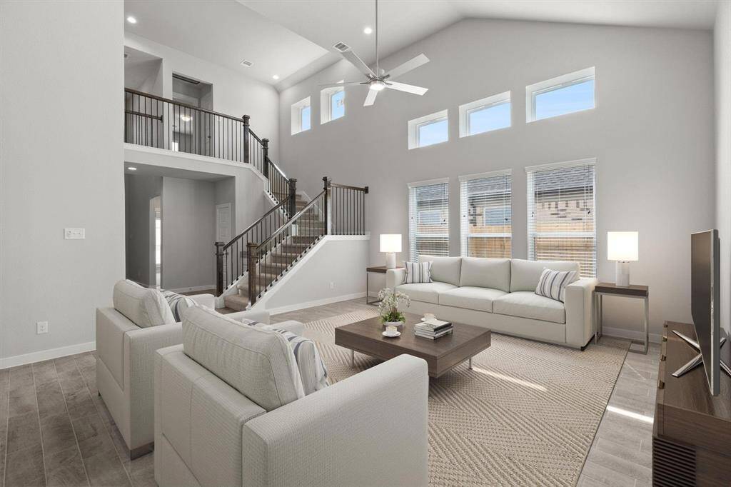 *Virtually Staged* Take another glimpse into the heart of the home with this additional view of the family room—a sprawling space ready to accommodate all your gatherings. Sample photo of completed home with similar floor plan. Actual colors and selections may vary.