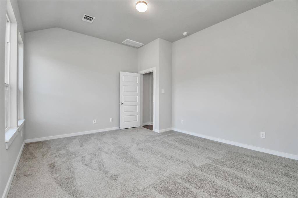 Indulge in relaxation in the magnificent primary suite following a busy day! This roomy haven showcases plush carpet, inviting paint colors, high ceilings, and generous windows with privacy blinds. Sample photo of completed home with similar floor plan. Actual colors and selections may vary.