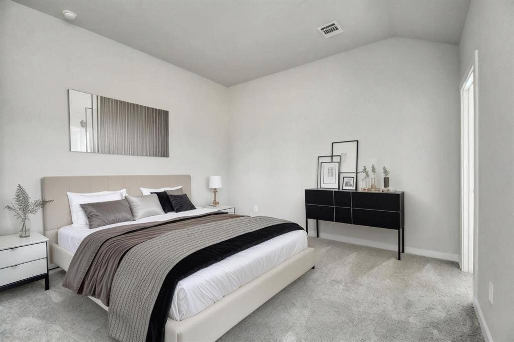 *Virtually Staged* Take another glimpse at the spacious and full of natural light primary bedroom. Sample photo of completed home with similar floor plan. Actual colors and selections may vary.
