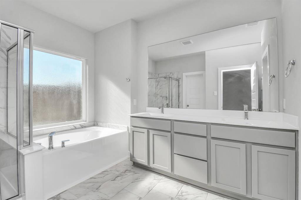 Another perspective of the spacious primary bathroom. Sample photo of completed home with similar floor plan. Actual colors and selections may vary.