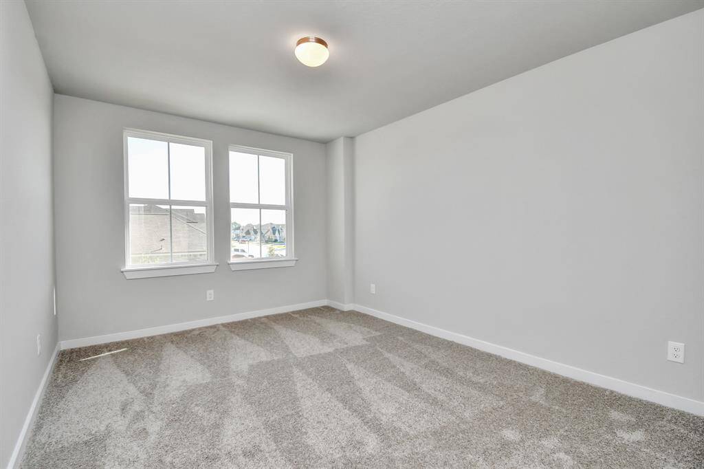 Another view of the secondary bedroom. Sample photo of completed home with similar floor plan. Actual colors and selections may vary.