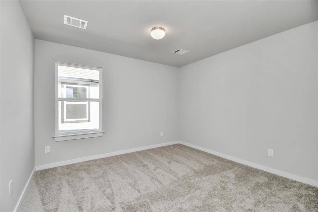 Another view of the secondary bedroom. Sample photo of completed home with similar floor plan. Actual colors and selections may vary.