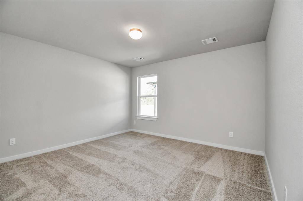 Another view of the secondary bedroom. Sample photo of completed home with similar floor plan. Actual colors and selections may vary.