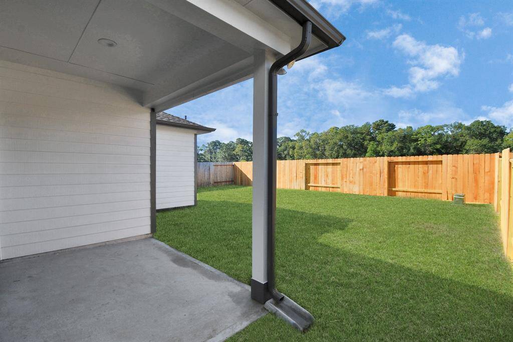 Discover the charm of this spacious backyard featuring a delightful covered patio. With ample room for both play and relaxation, it's the perfect outdoor haven. Tailor this space to your liking with patio furniture, a BBQ pit, and more. The potential for creating your dream outdoor living area is limitless! Sample photo of completed home with similar floor plan. Actual colors and selections may vary.