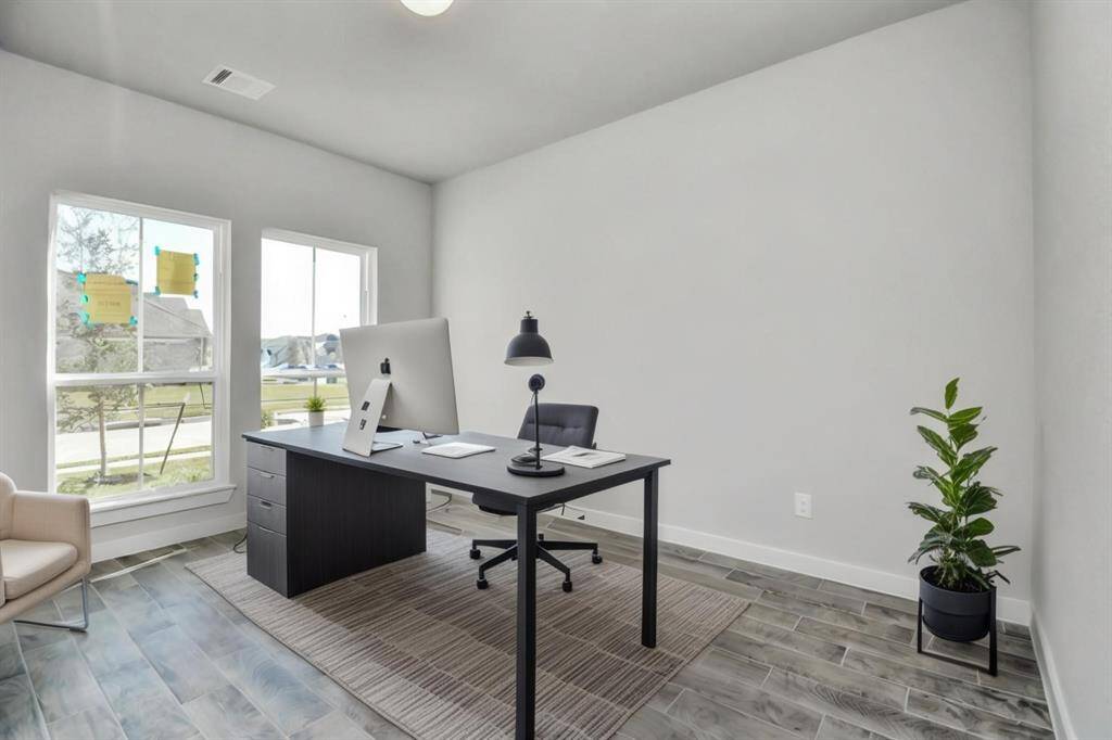 *Virtually Staged* Step into the inviting home office, where elegant tile flooring adds a touch of freshness and comfort to the workspace. Natural light pours through the window, creating an inspiring environment for productivity and focus. Sample photo of completed home with similar floor plan. Actual colors and selections may vary.