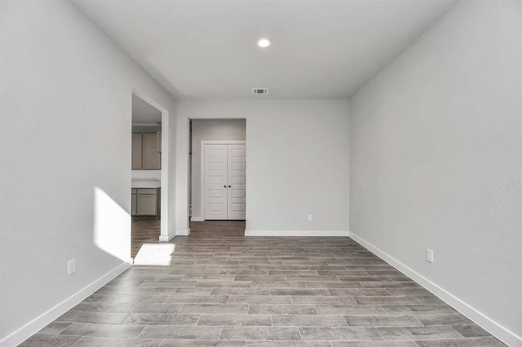 Make memories gathered around the table with your family and friends! This spacious dining room features elegant flooring, custom paint, and adjacent to family room and kitchen for open concept feel. Sample photo of completed home with similar floor plan. Actual colors and selections may vary.