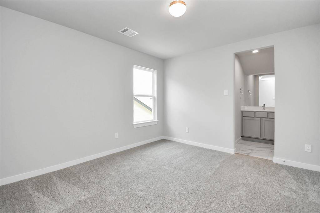 Secondary bedroom features plush carpet, custom paint, large window with privacy blinds and access to the Jack and Jill bath. Sample photo of completed home with same plan. Actual colors and selections may vary.