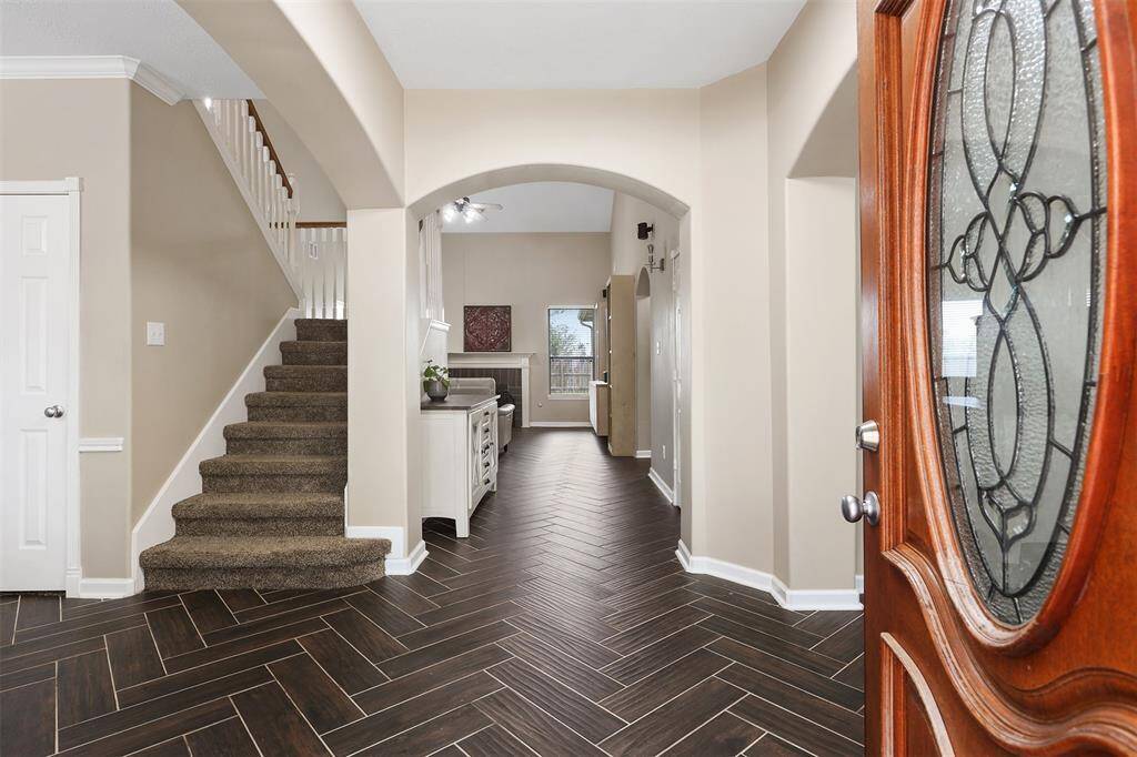 Step Through the Beautiful Leaded Glass Front Door and You are Greeted by the Gorgeous Custom Herringbone Wood-Look Floors Practically Maintenace Free!