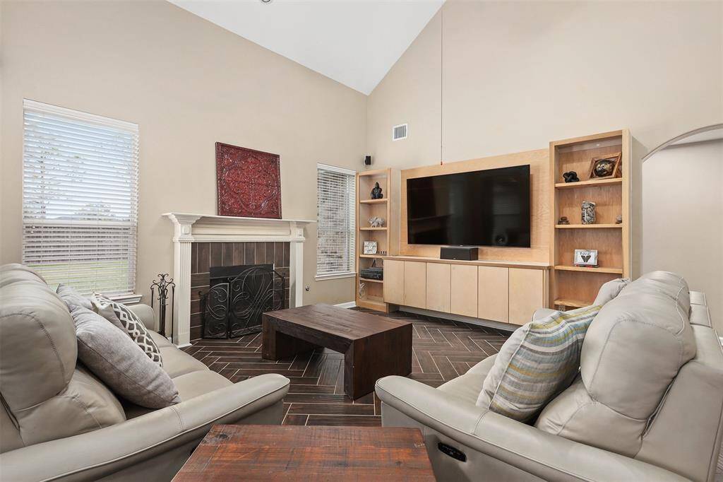 Soaring Ceilings, Cozy Fireplace & Built-In Entertainment Center Make this Family a Great Place to Hang Out