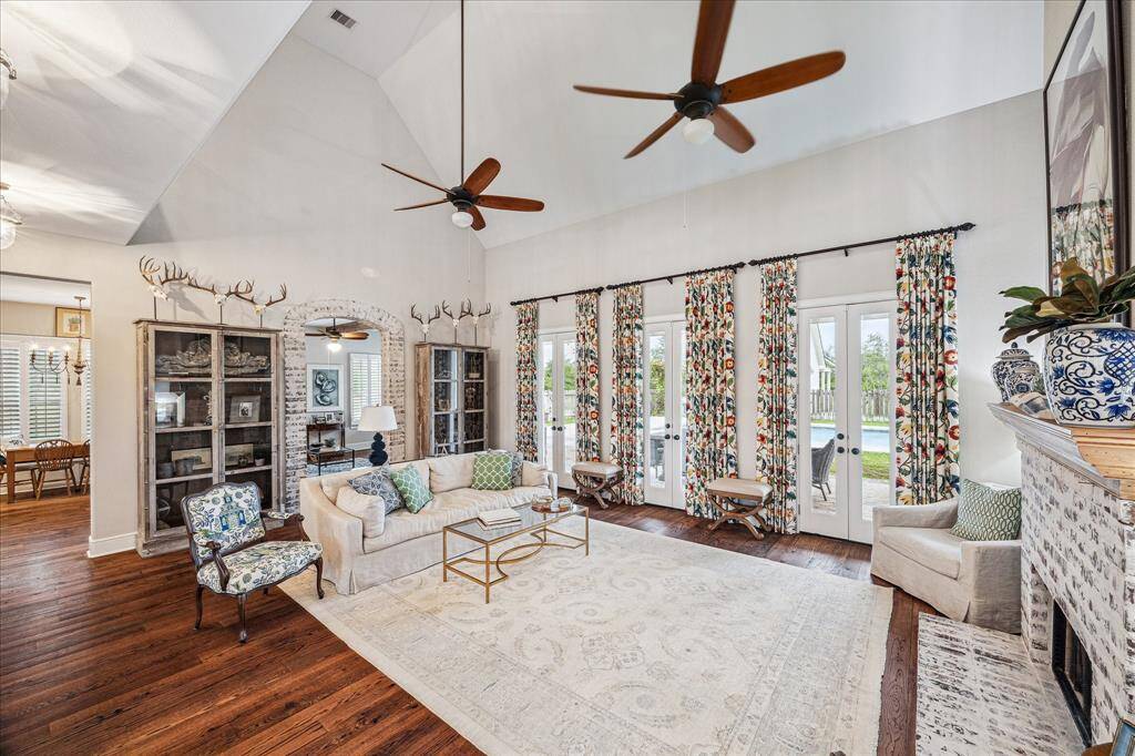 THE WALL OF GLASS-PANED FUNCTIONAL DOUBLE FRENCH DOORS OFFER VIEWS OUT TO THE COVERED BACK PORCH DINING AREA (DINING TABLE INCLUDED)