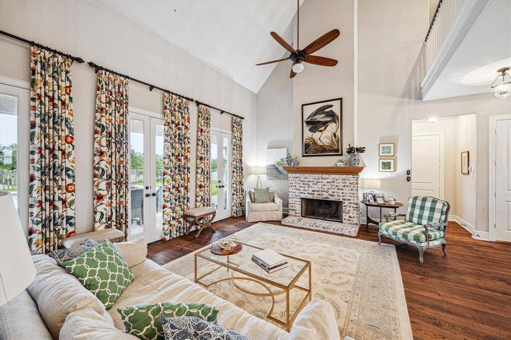 GAS/WOOD BURNING FIREPLACE OFFERS A LARGE ART AREA ABOVE THE CUSTOM CYPRESS MANTLE