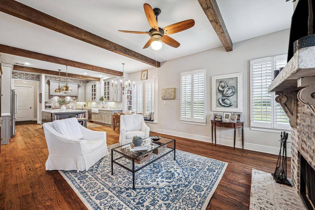 A BEAUTIFUL BRICK CHIMNEY WITH CUSTOM SOLID MANTLE WITH ANTIQUE CORBELS OVER A GAS LOG DOUBLE-SIDED FIREPLACE OPENS TO THE KITCHEN AND BREAKFAST AREAS OFFERING A PERFECT SETTING FOR FAMILY GATHERINGS