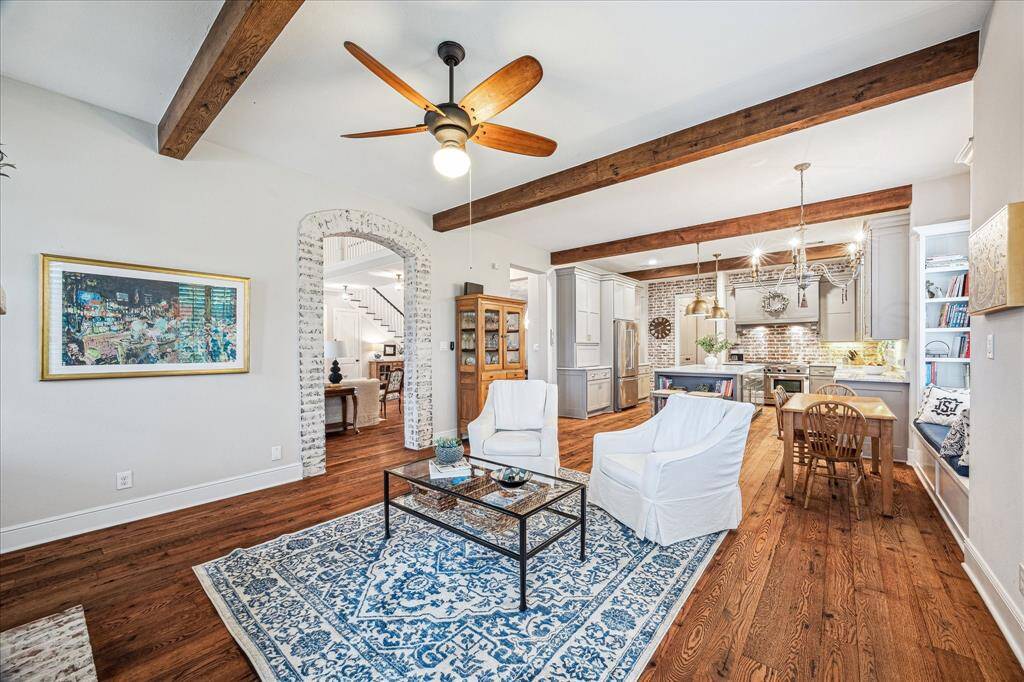 THE WOODED BEAMS ADD ARCHITECTURAL INTEREST AND A RICH ELEGANCE. NOTICE THE STUNNING BRICK ARCHWAY FROM FORMAL DINING TO FAMILY ROOM