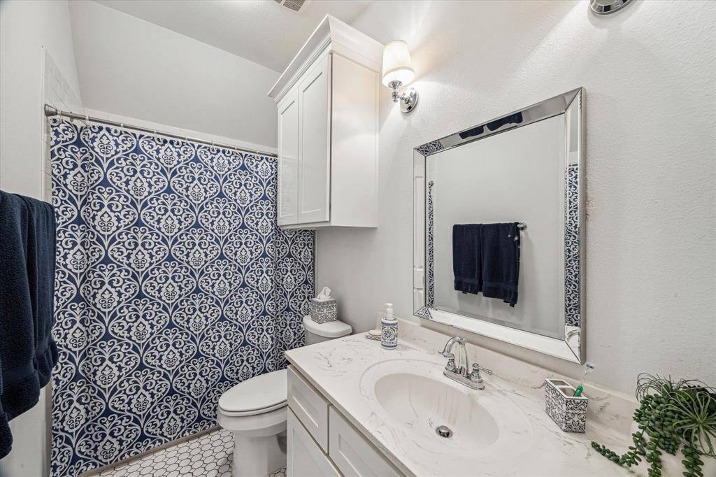 THIS 3RD FULL BATH ROOM SITS OUTSIDE OF THE 4TH BEDROOM AND AT THE GAME ROOM AREA