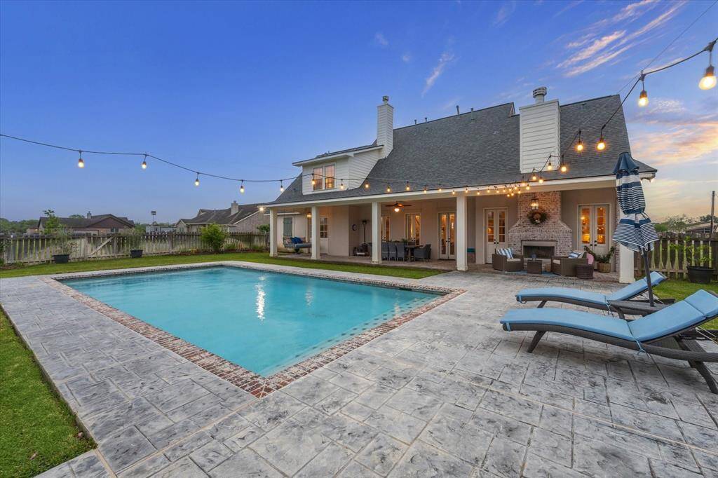 SPLASH INTO OUR REFRESHING POOL THIS SUMMER! STAMPED CONCRETE SURROUNDS THE POOL WITH PLENTY OF ROOM FOR OUTDOOR FURNITURE
