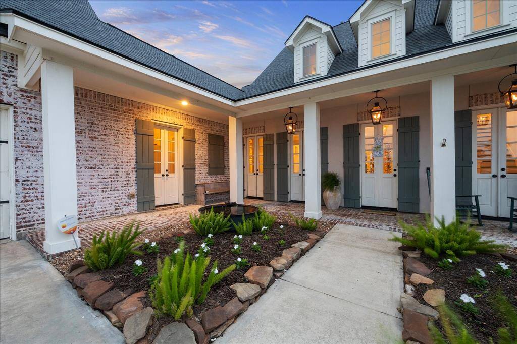 LUSH LANDSCAPING GREETS YOU AS YOU ENTER BOTH THE FRONT ENTRANCES W/ GLASS-PANED, DOUBLE FRENCH DOORS INCLUDING AN ENTRANCE TO THE UTILITY ROOM TO THE LEFT.