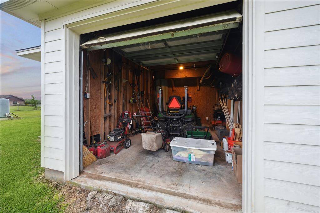 UTILITY GARAGE SITS IN THE BACK OF THE OUT BUILDING  -TRACTOR NEGOTIABLE