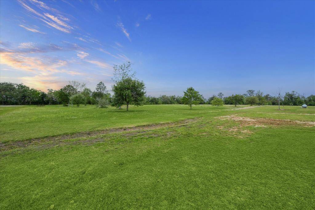 ANOTHER VIEW OF THE ACREAGE BESIDE THE HOME ON A CUL- DE- SAC STREET