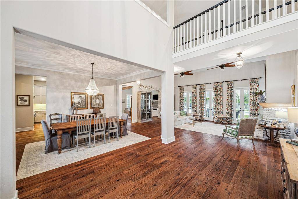 WOW! ISN'T THIS A STUNNING FOYER! CUSTOM CHANDELIERS AND LIGHTING THROUGHOUT THE HOME/ CATWALK ABOVE