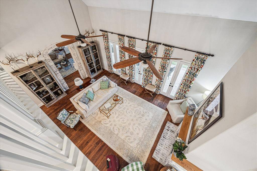 28’ CEILINGS IN FORMAL LIVING ROOM AND FOYER- UPSTAIRS SUSPENDED CATWALK HALLWAY (AND LOFT AREA) WITH BANNISTER RAILING OVERLOOKING THE EXPANSIVE DOWNSTAIRS LIVING AREAS