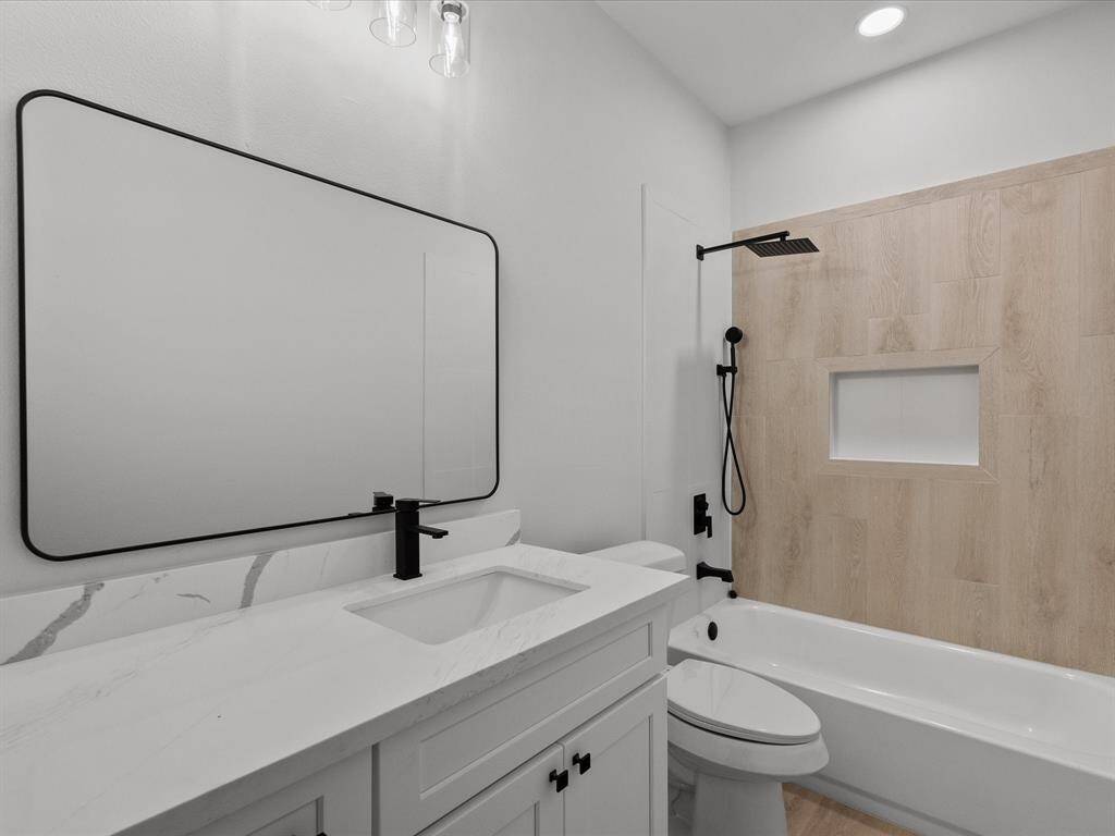 Primary Bath with generous Sized Vanity and Stylish Bath Surround.