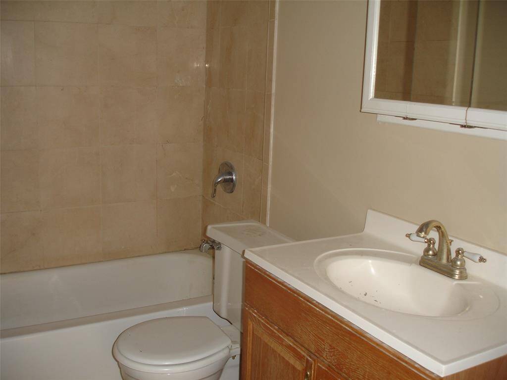 Back Bedroom with two windows and lovely hardwood floors.