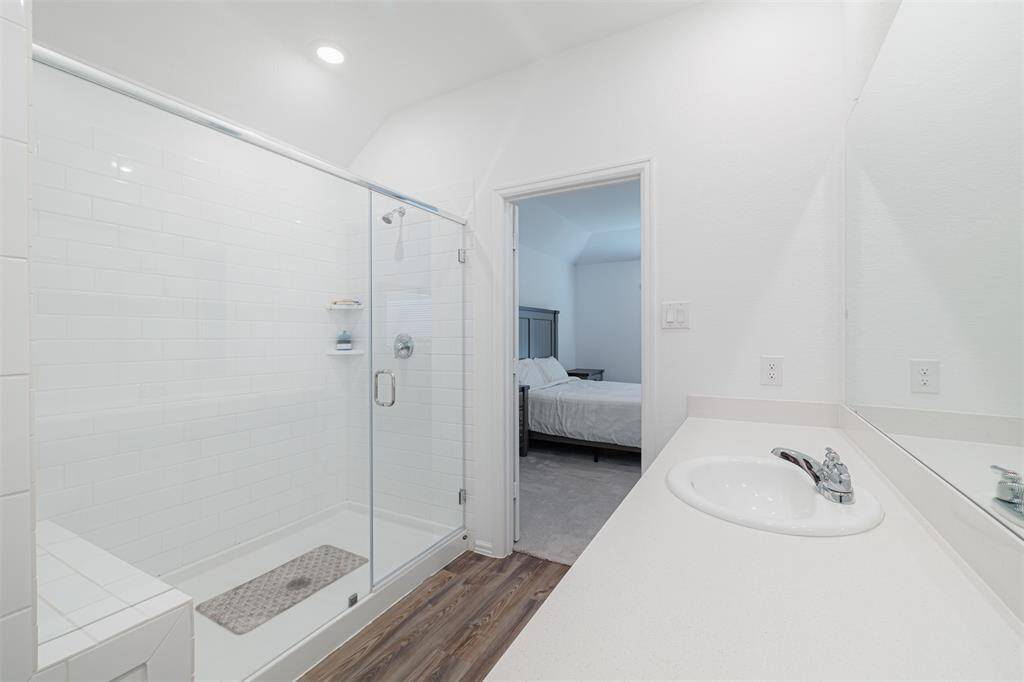 The ensuite bath with an oversized walk-in shower and generous closet.