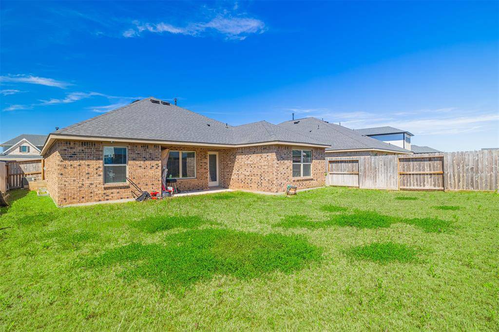 Enjoy outdoor living in the sizable backyard with a covered patio and sprinkler system.