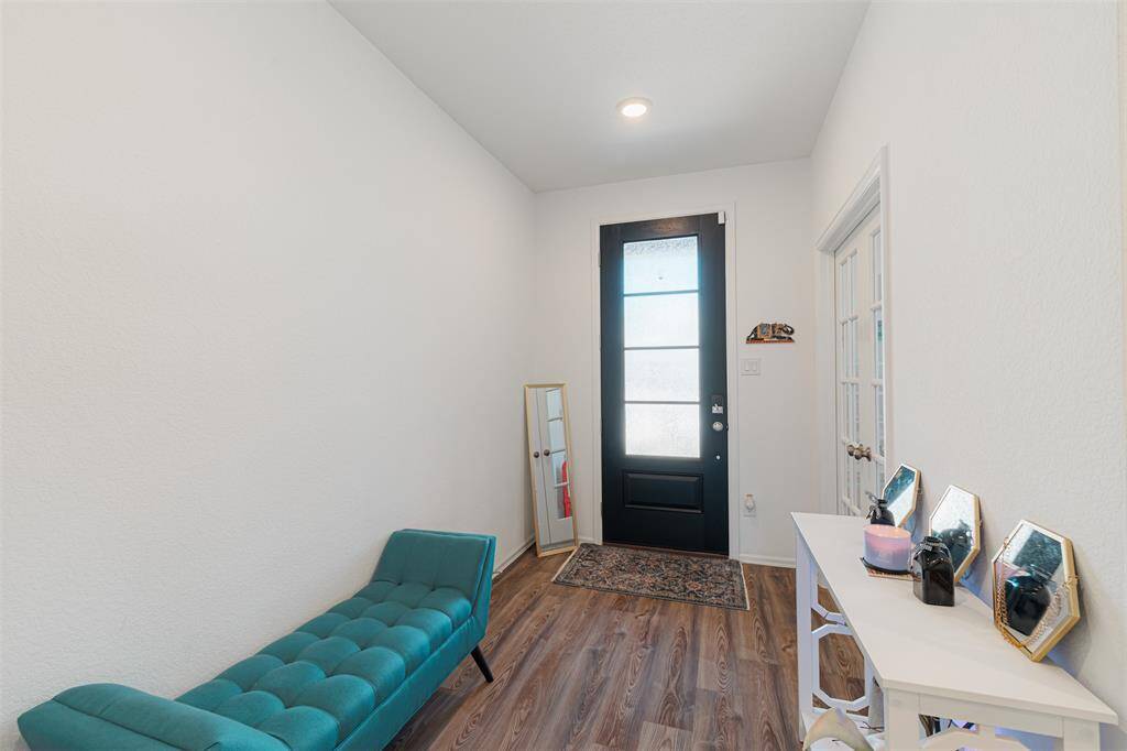 A welcoming entryway opens to a private study.