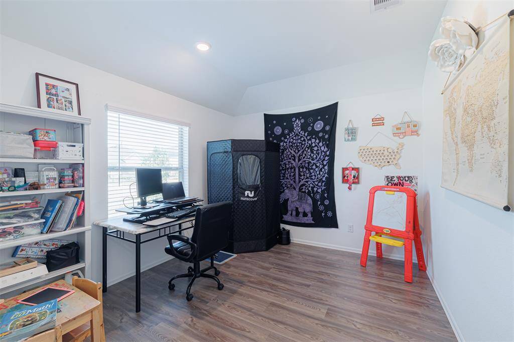 The private study with elegant French doors and luxury vinyl flooring.