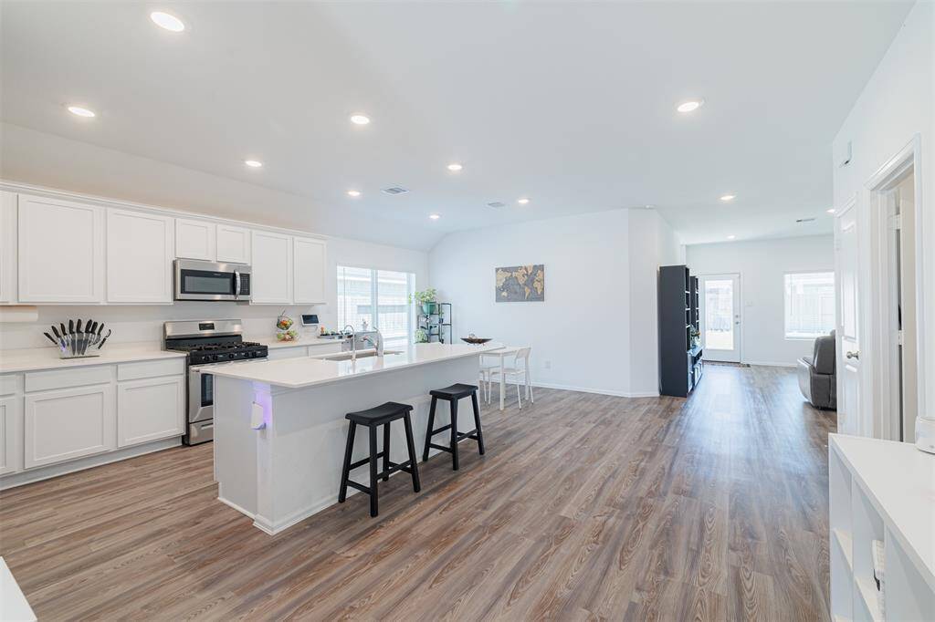 Island kitchen and breakfast room boasts quartz counters and breakfast bar.