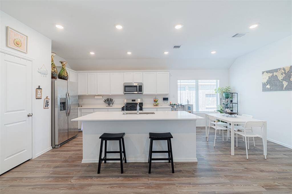 Kitchen also features recessed lighting, luxury vinyl flooring and stainless steel appliances.