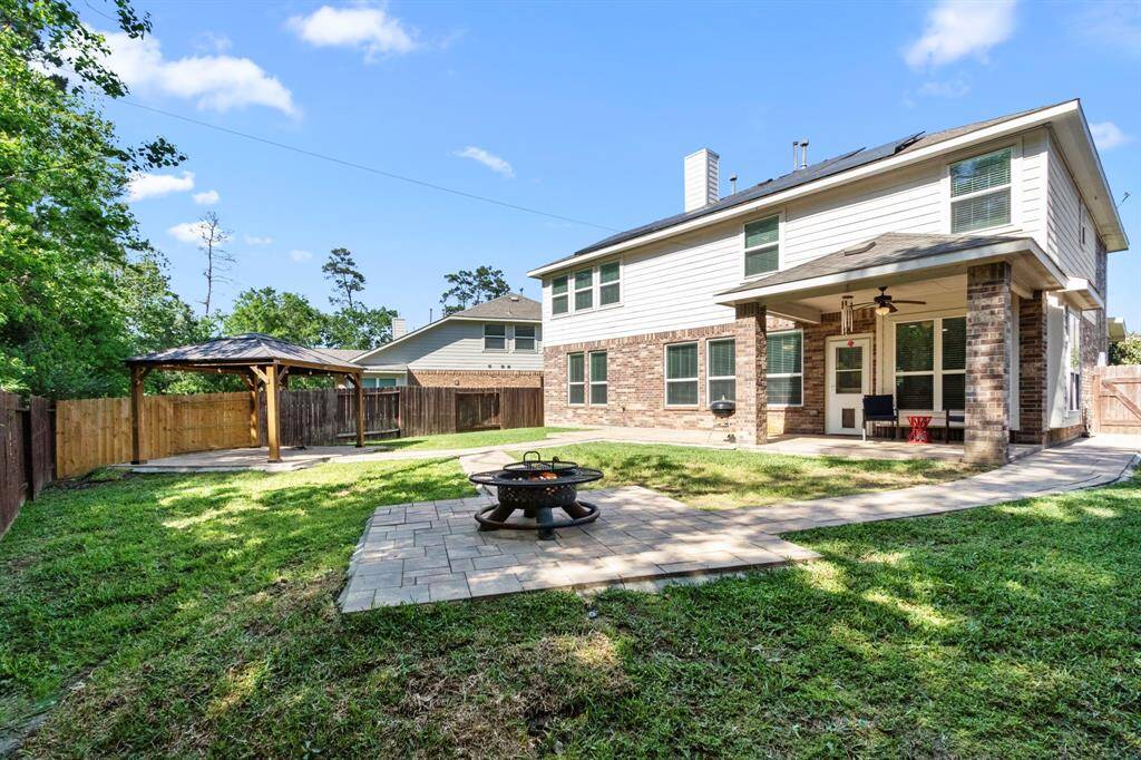 Backyard has been made with plenty of space to gather around a fire or under the gazebo which stays